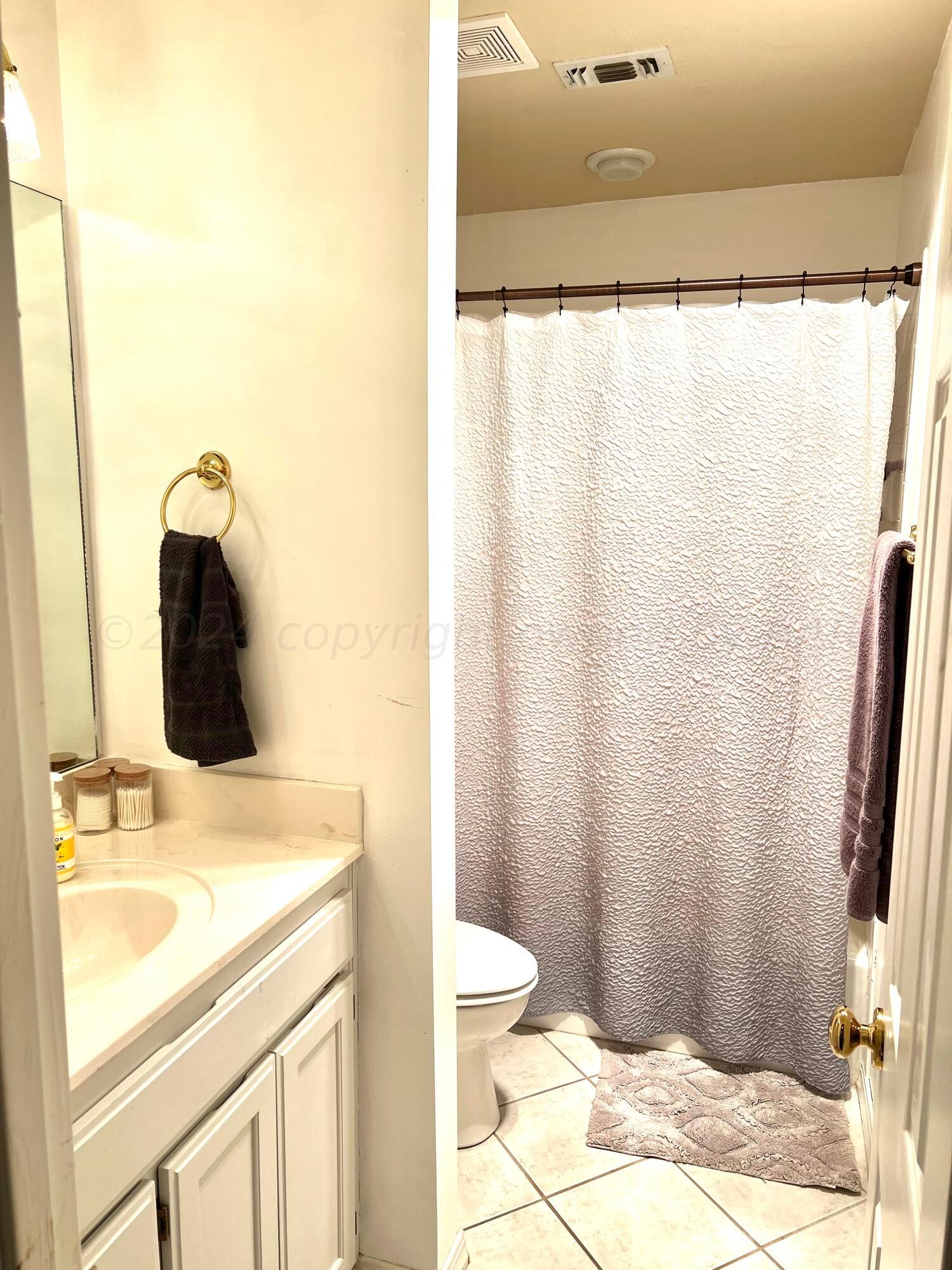 5801 South Bowie Street Amarillo, TX 79118 - Photo 12 of 23 a bathroom with a sink and a mirror