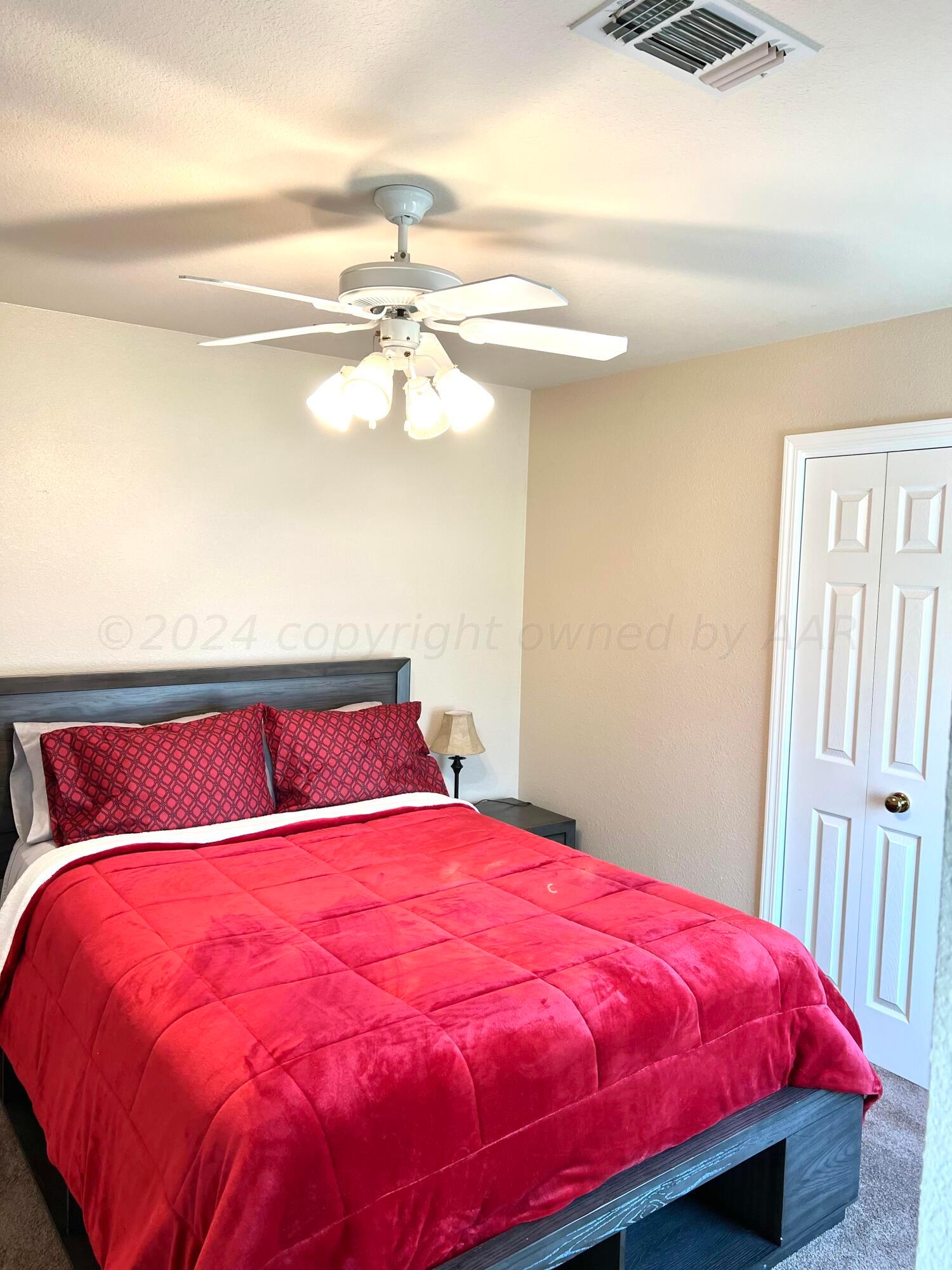 5801 South Bowie Street Amarillo, TX 79118 - Photo 13 of 23 a bed sitting in a bedroom next to a window