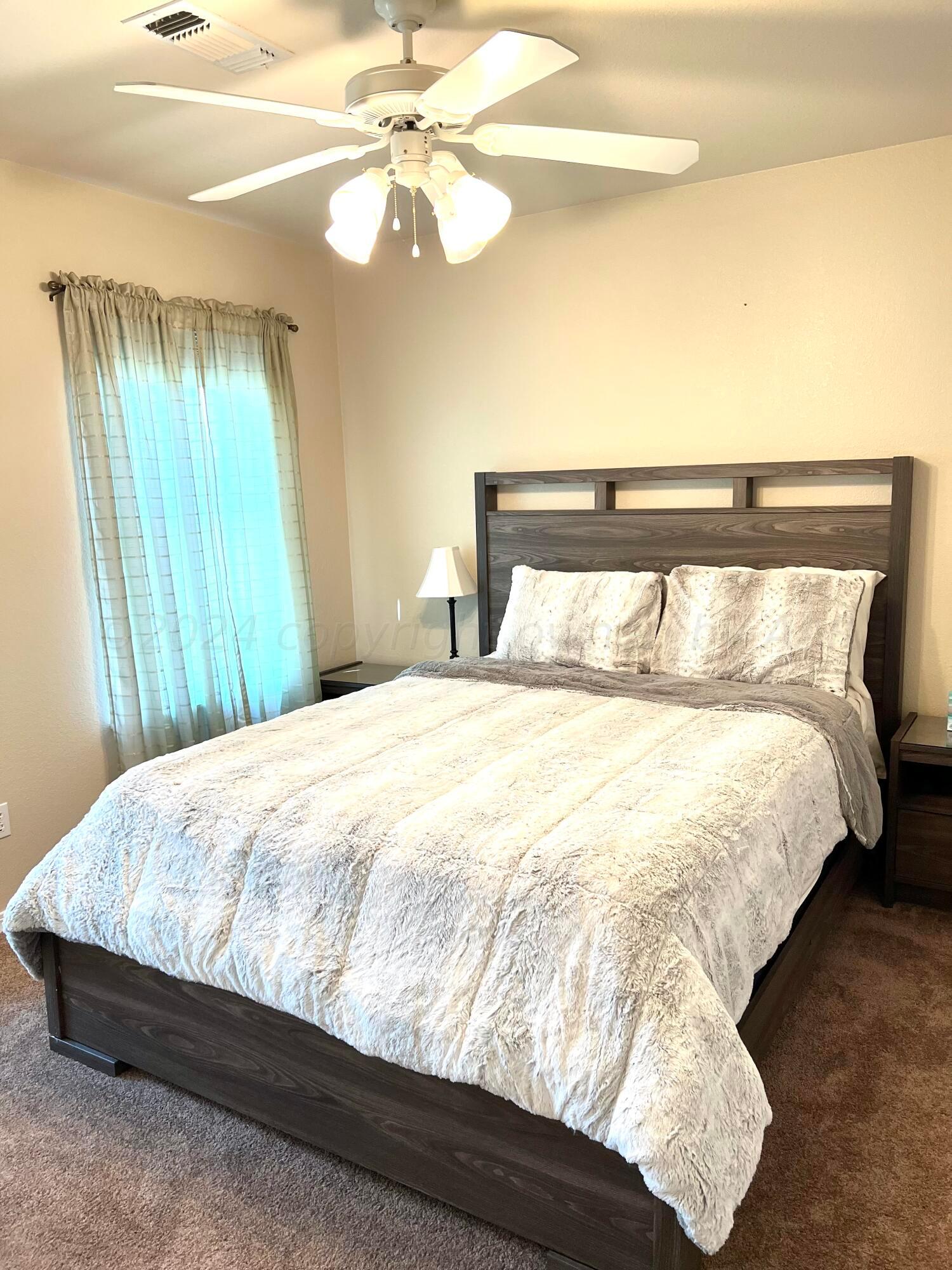 5801 South Bowie Street Amarillo, TX 79118 - Photo 15 of 23 a bed sitting in a bedroom next to a window