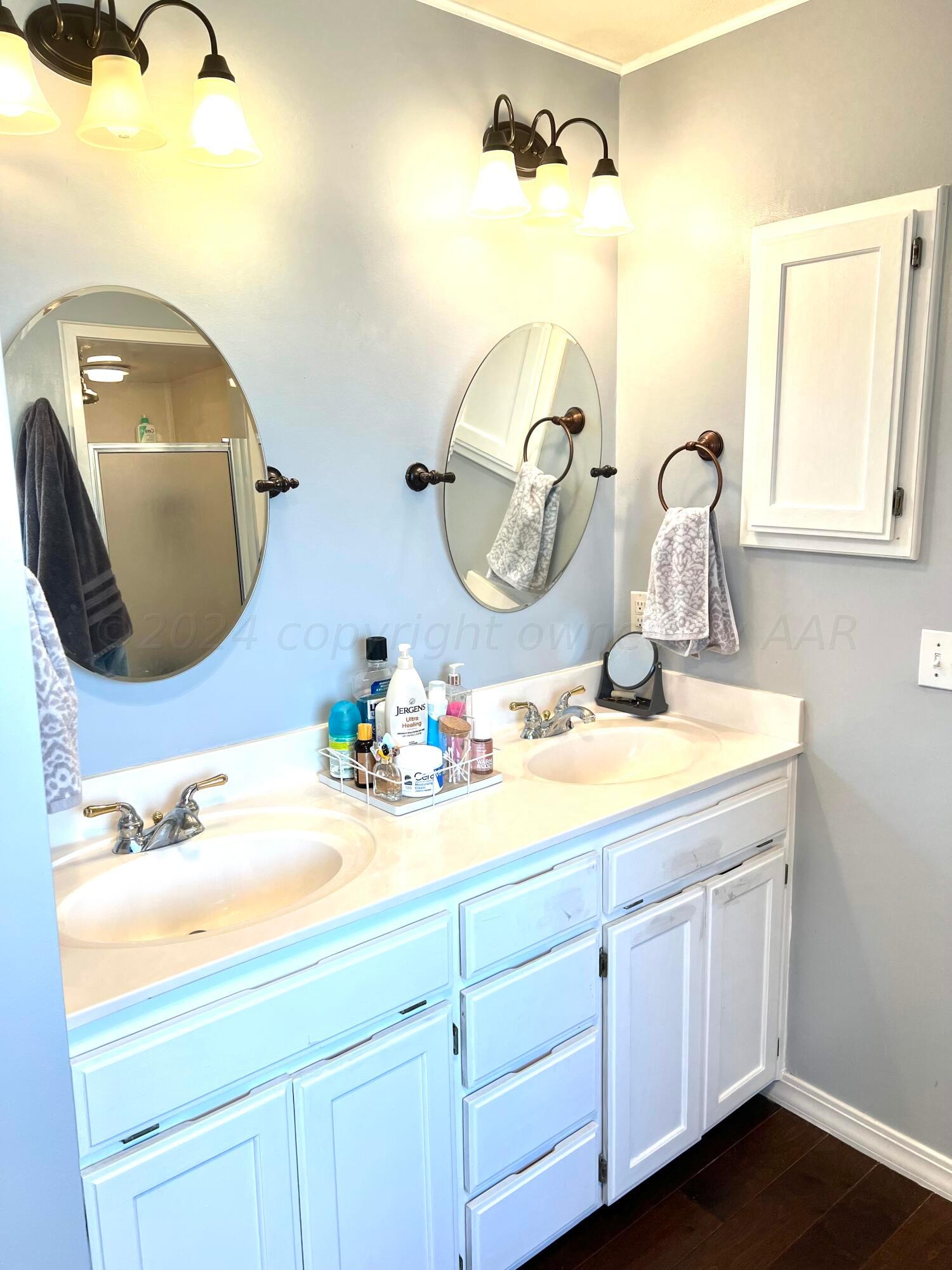 5801 South Bowie Street Amarillo, TX 79118 - Photo 18 of 23 a bathroom with a sink and a mirror