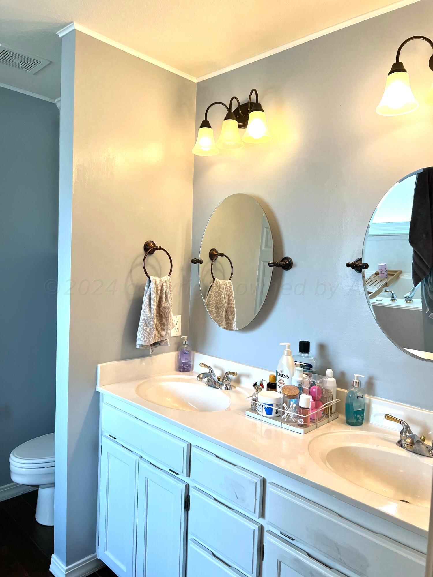 5801 South Bowie Street Amarillo, TX 79118 - Photo 19 of 23 a bathroom with a sink and a mirror