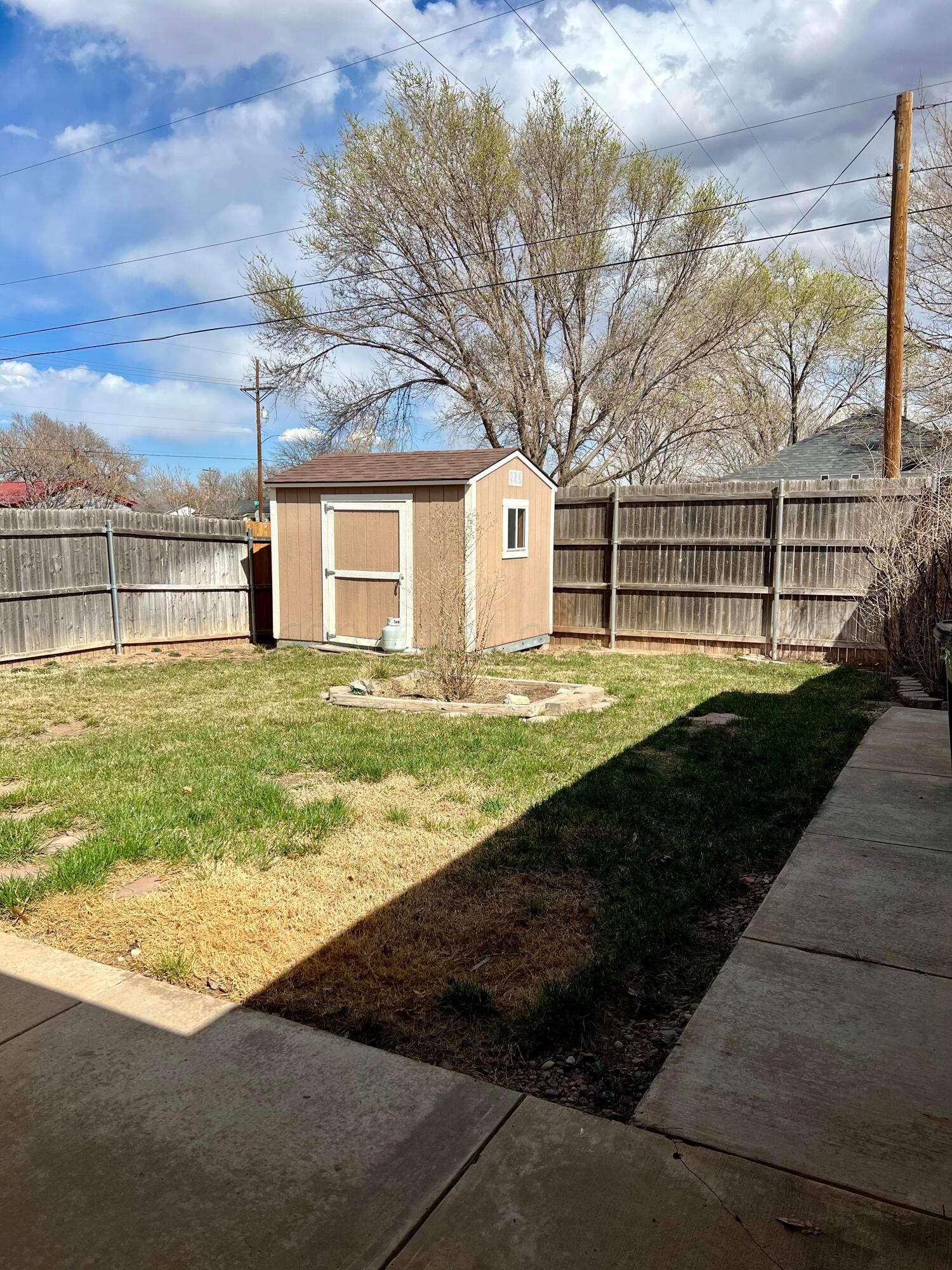 5801 South Bowie Street Amarillo, TX 79118 - Photo 21 of 23 a front view of a house with a yard