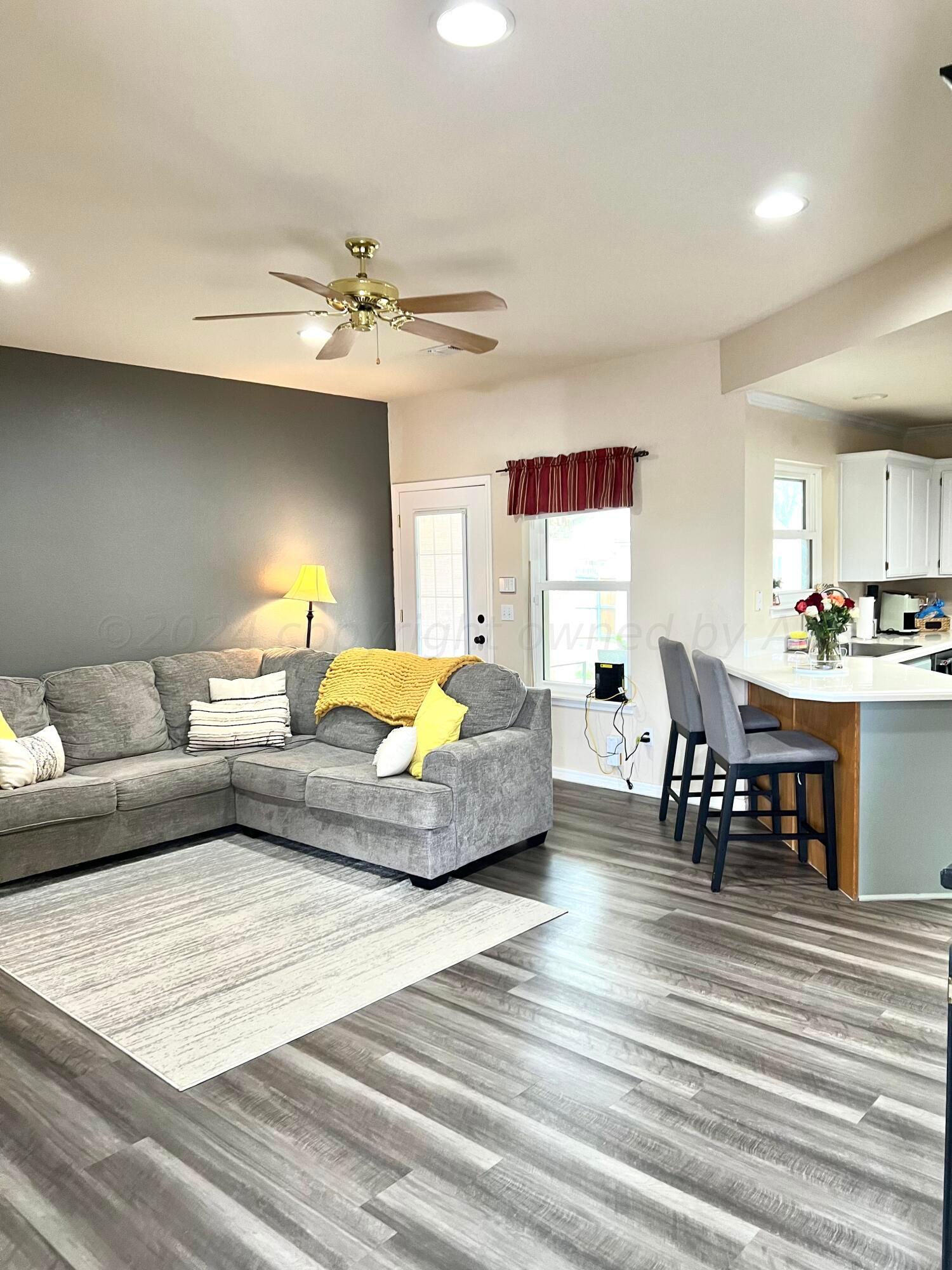 5801 South Bowie Street Amarillo, TX 79118 - Photo 5 of 23 a living room with furniture and a chandelier