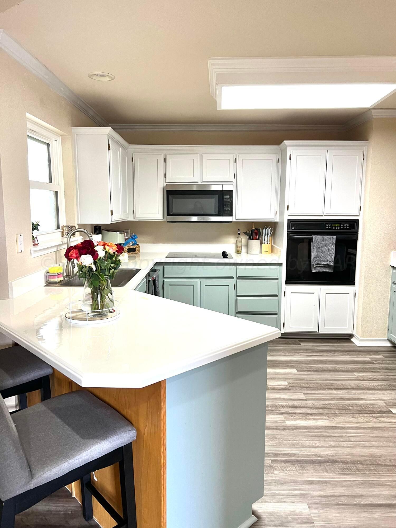 5801 South Bowie Street Amarillo, TX 79118 - Photo 6 of 23 a kitchen with stainless steel appliances kitchen island sink refrigerator and stove