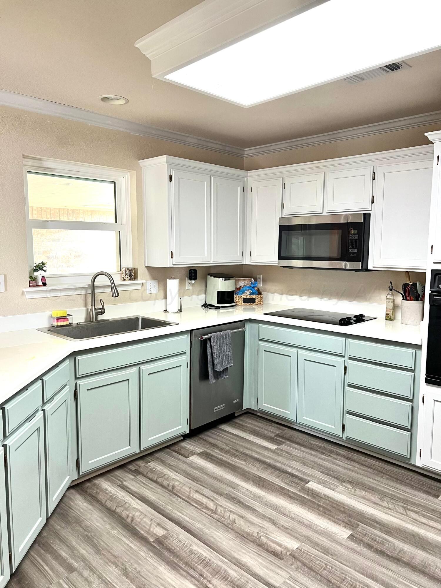 5801 South Bowie Street Amarillo, TX 79118 - Photo 7 of 23 a kitchen with a sink stove and microwave