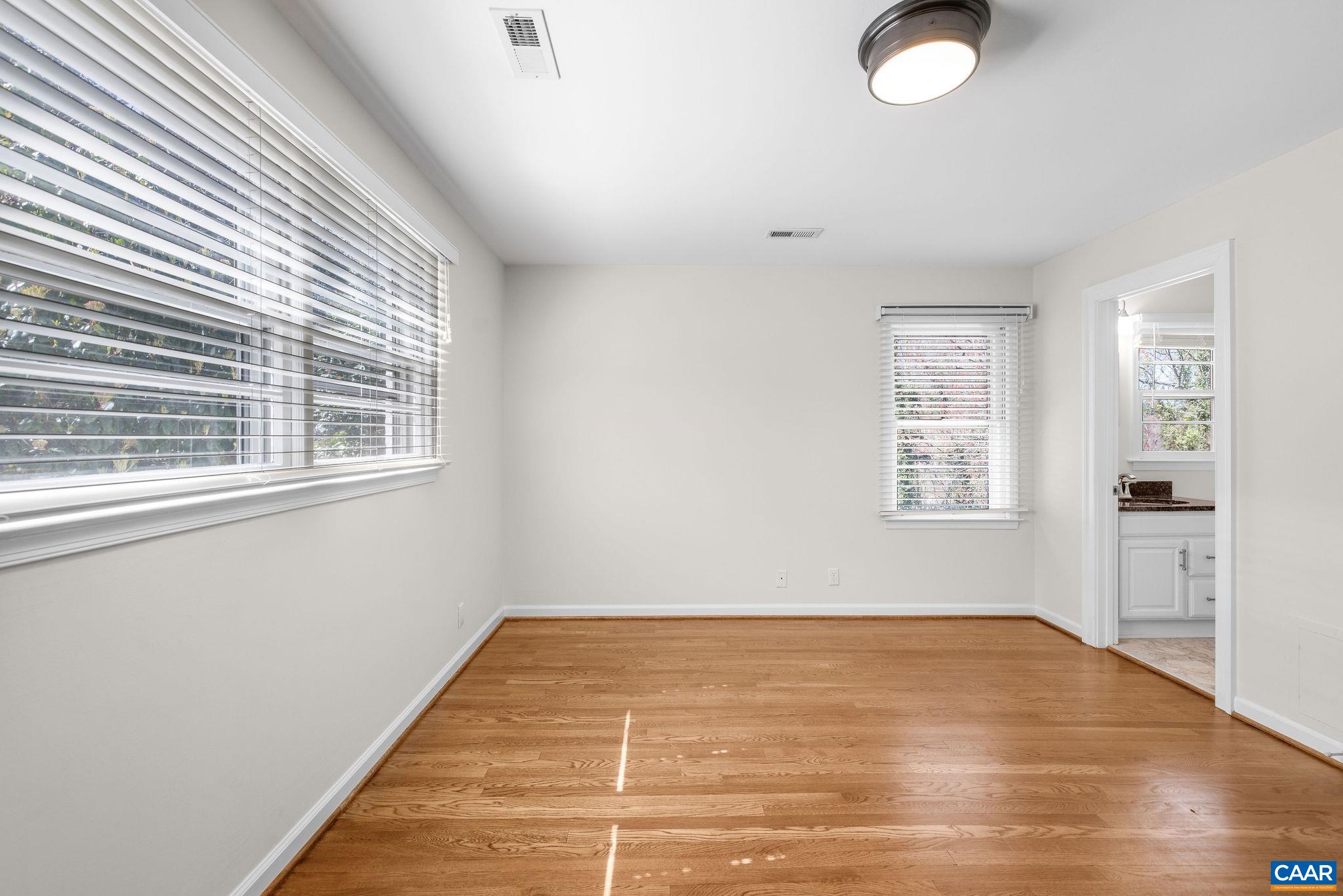 26 University Circle Charlottesville, VA 22903 - Photo 29 of 38 a view of empty room with wooden floor and fan