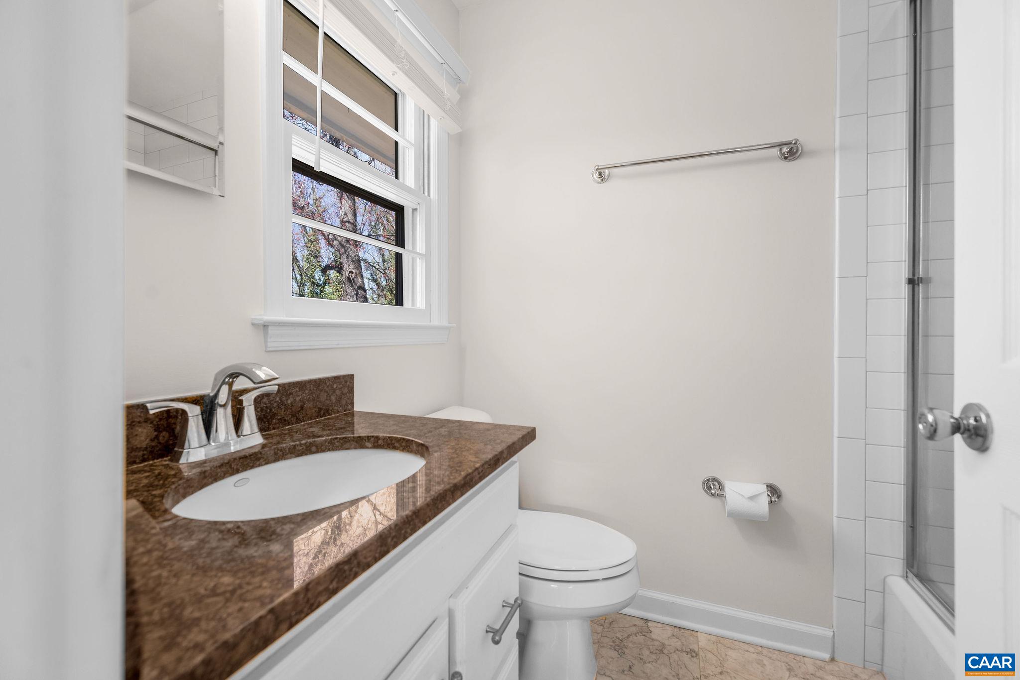 26 University Circle Charlottesville, VA 22903 - Photo 30 of 38 a bathroom with a granite countertop sink and a mirror