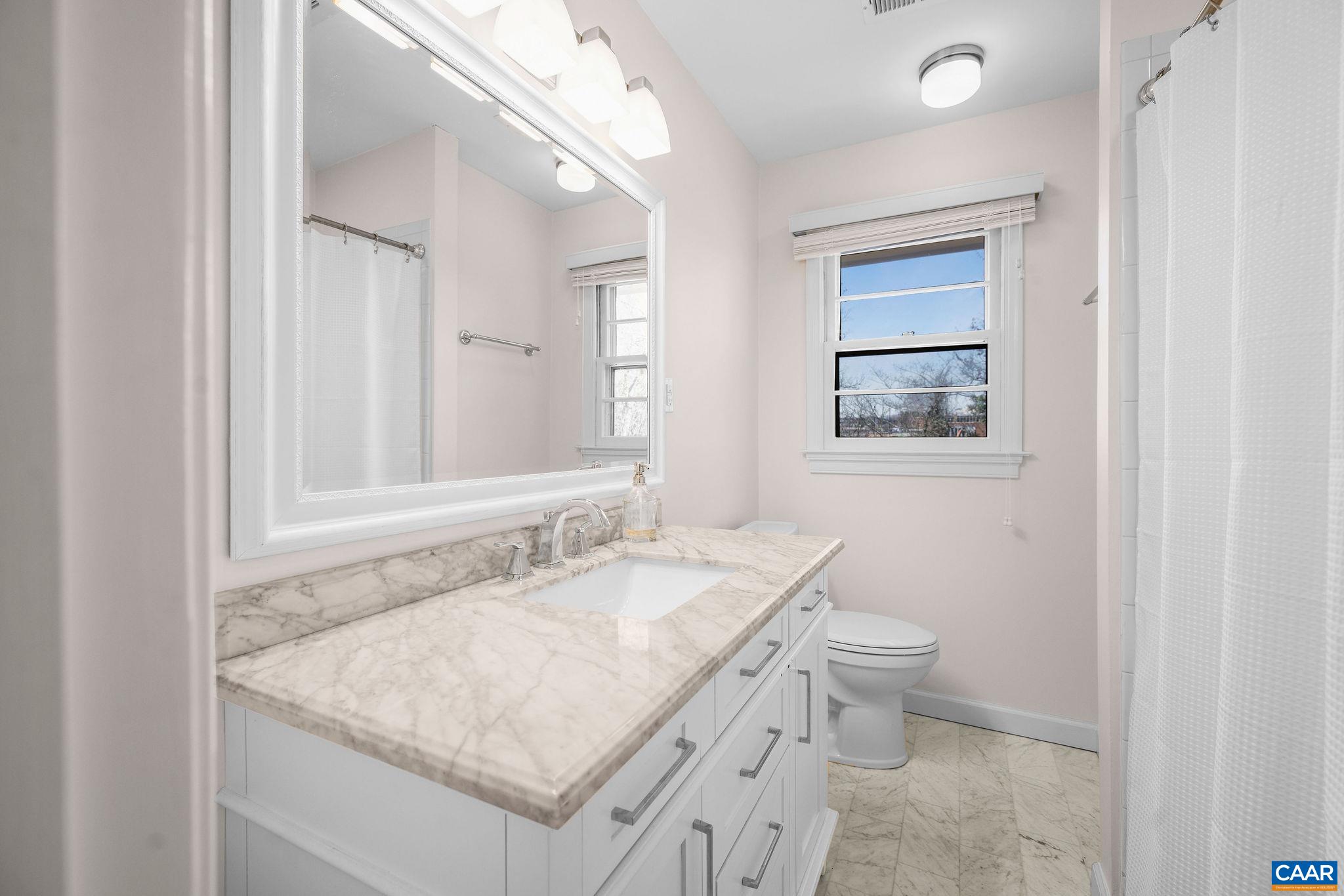 26 University Circle Charlottesville, VA 22903 - Photo 31 of 38 a bathroom with a granite countertop sink a toilet and mirror
