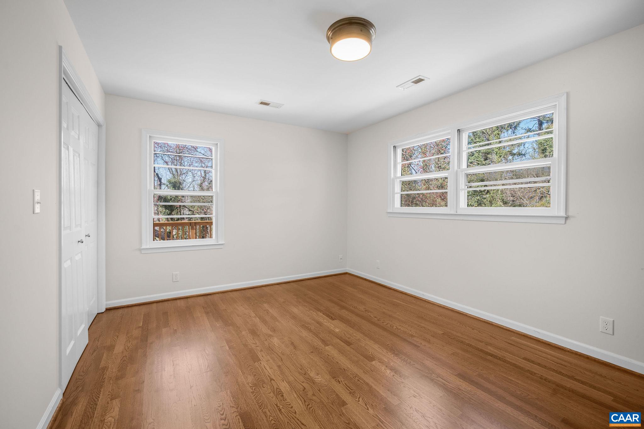 26 University Circle Charlottesville, VA 22903 - Photo 36 of 38 an empty room with wooden floor and windows