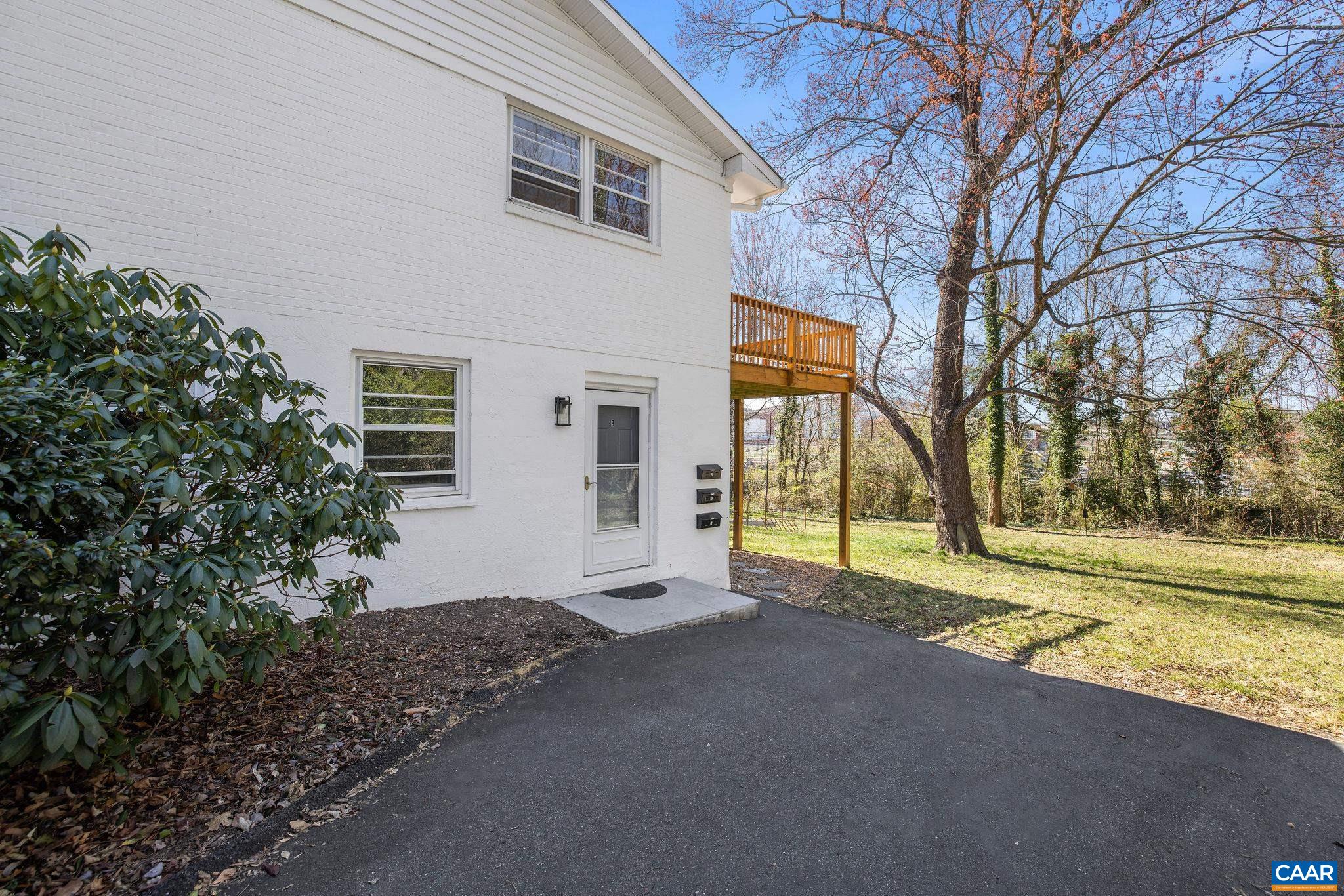 26 University Circle Charlottesville, VA 22903 - Photo 9 of 38 a view of a house with a big yard and potted plants