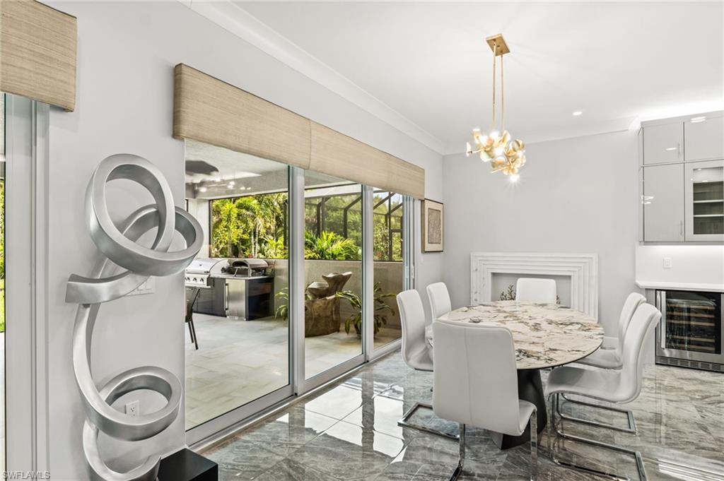 12033 Azalea Way Naples, FL 34120 - Photo 9 of 46 Stunning dining room with fireplace facade and 2 sets of sliders to the lanai