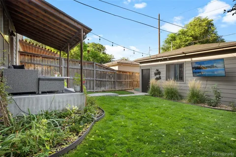 a view of a backyard with plants and a patio
