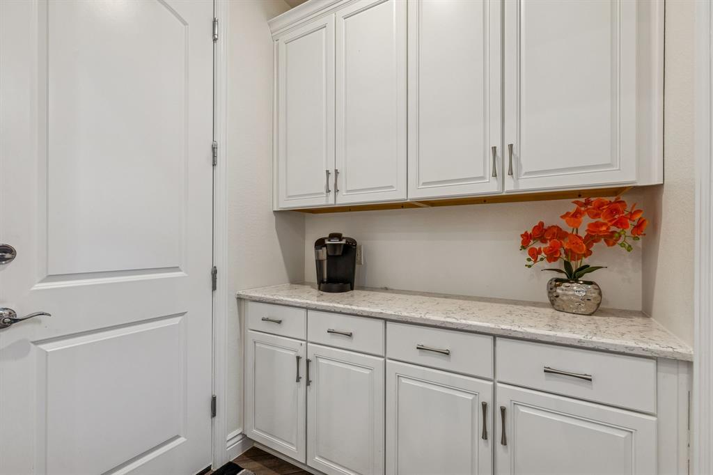 8717 Basanite Avenue Denton, TX 76207 - Photo 12 of 30 a kitchen with white cabinets and a sink