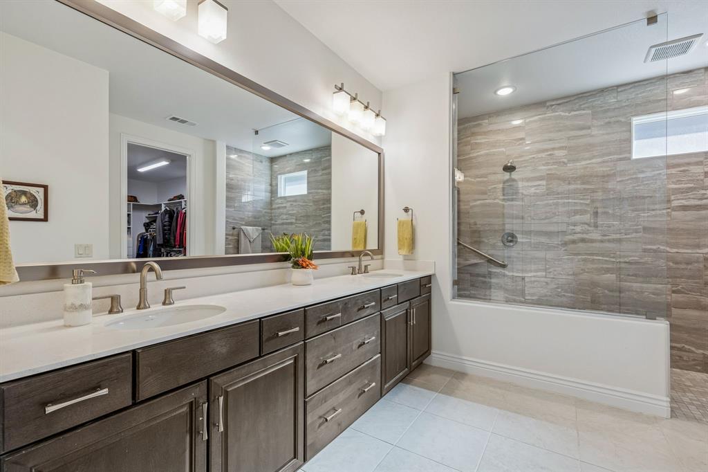8717 Basanite Avenue Denton, TX 76207 - Photo 17 of 30 a bathroom with a double vanity sink mirror double and bathtub