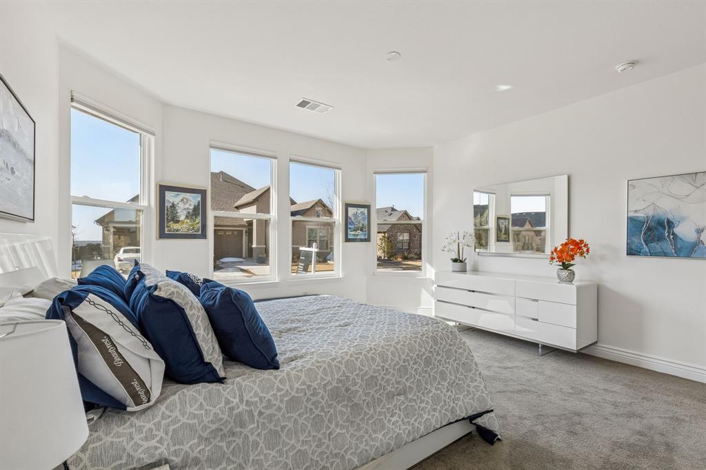 8717 Basanite Avenue Denton, TX 76207 - Photo 24 of 30 a spacious bedroom with a bed and a large window