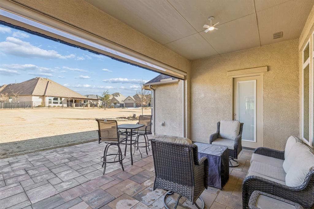 8717 Basanite Avenue Denton, TX 76207 - Photo 29 of 30 a view of a dining room with furniture and a rug