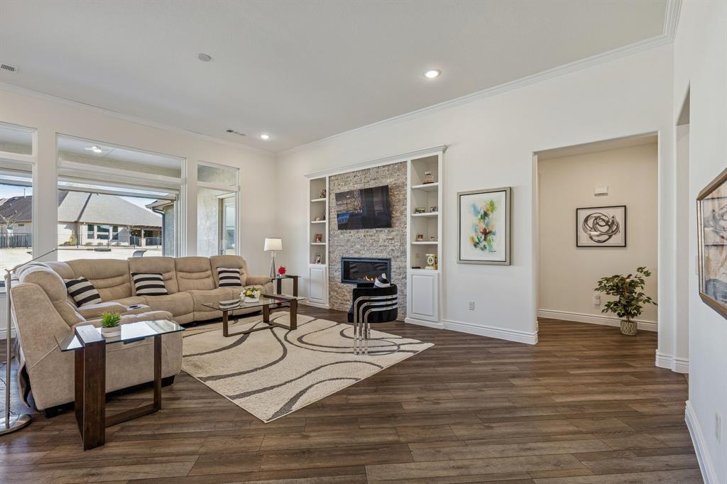 8717 Basanite Avenue Denton, TX 76207 - Photo 5 of 30 a living room with furniture and a fireplace