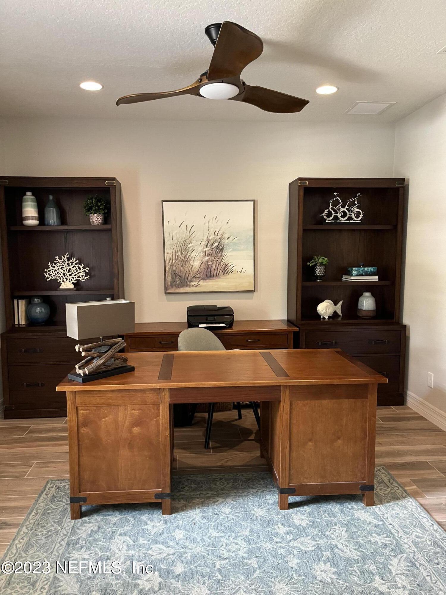 100 Tree Side Lane Ponte Vedra, FL 32081 - Photo 116 of 118 a room with furniture a desk and wooden floor