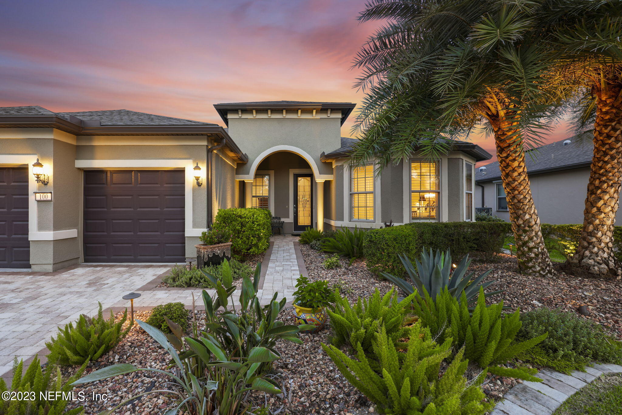 100 Tree Side Lane Ponte Vedra, FL 32081 - Photo 46 of 118 a front view of a house with a garden