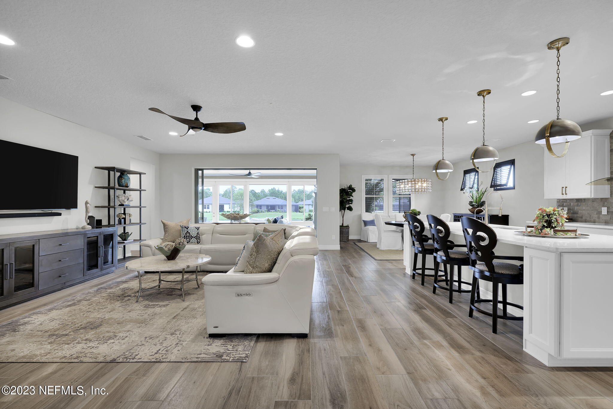 100 Tree Side Lane Ponte Vedra, FL 32081 - Photo 9 of 118 a living room with furniture kitchen view and a flat screen tv