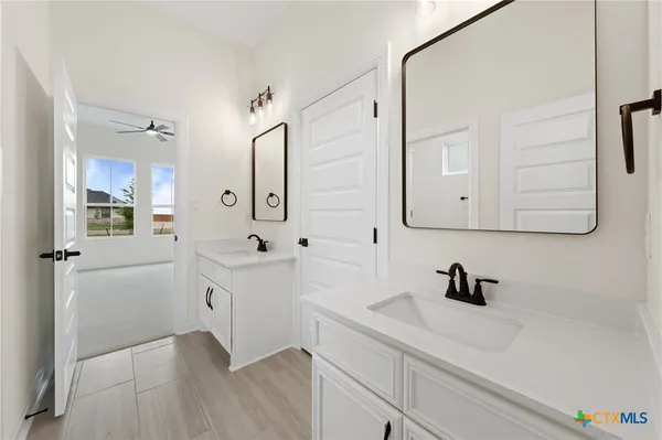 a bathroom with a sink a tub and mirror