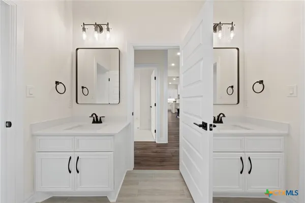 a bathroom with a sink a toilet and mirror