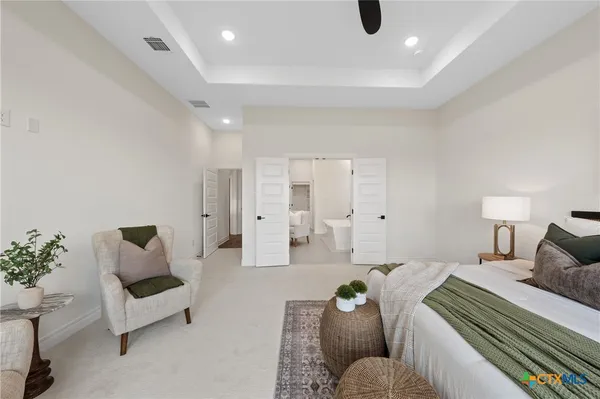 a bathroom with a sink mirror and a bathtub