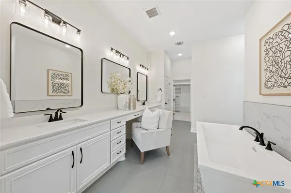 a bathroom with a shower sink and mirror