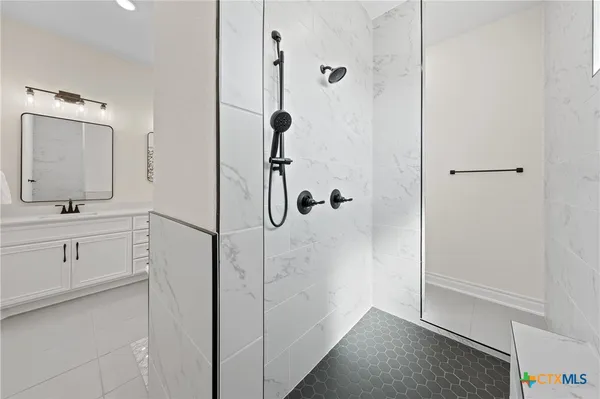 a bathroom with a tub and a shower