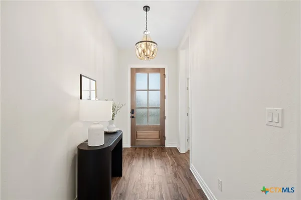 a view of an entryway with wooden floor