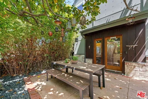 a backyard of a house with outdoor seating