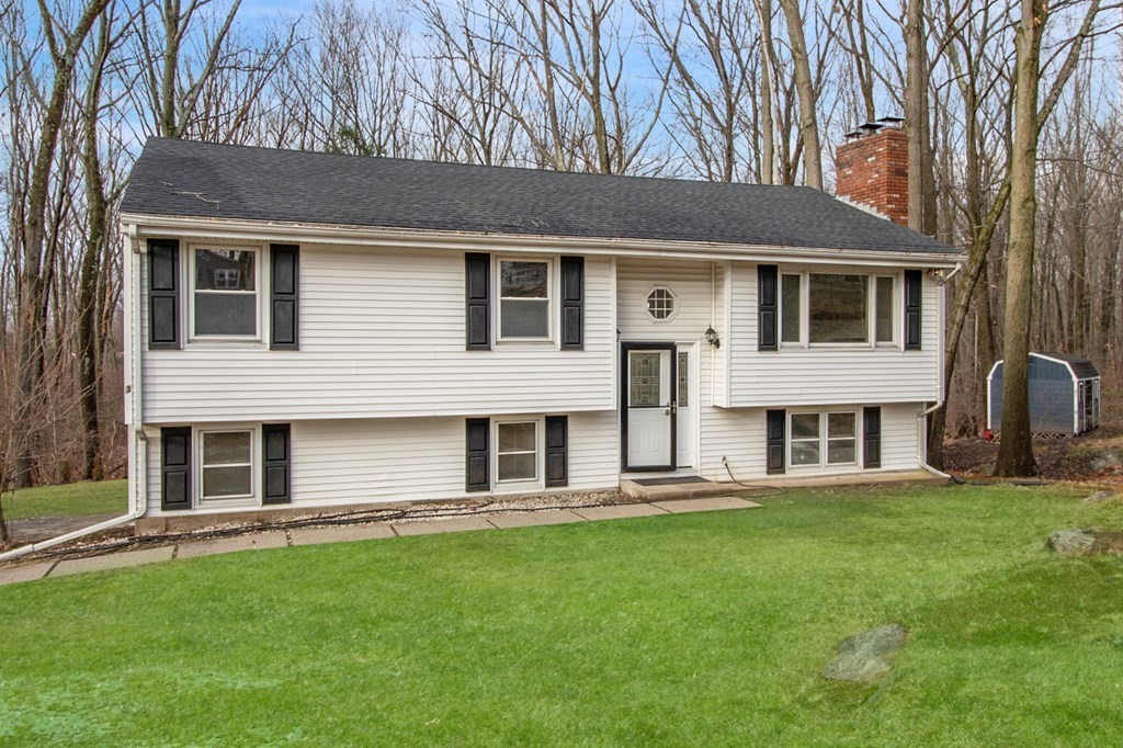 3 Colonial Road Sutton, MA 01590 - Photo 1 of 26 a front view of a house with a yard