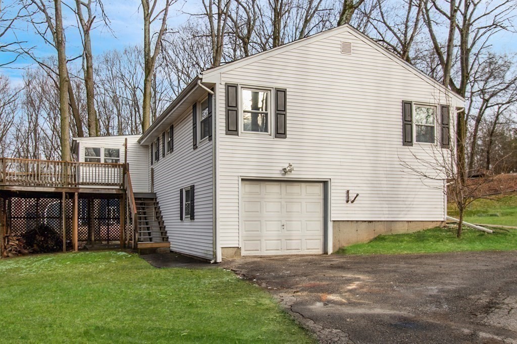 3 Colonial Road Sutton, MA 01590 - Photo 24 of 26 a view of a white house next to a yard and large trees