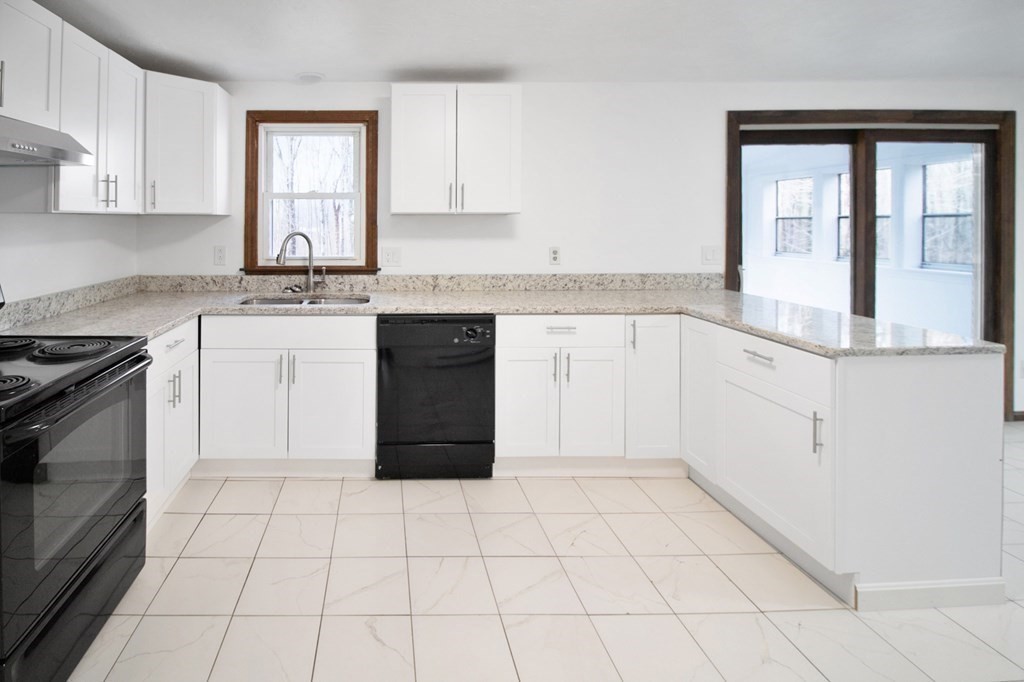 3 Colonial Road Sutton, MA 01590 - Photo 4 of 26 a kitchen with a stove a sink and a refrigerator