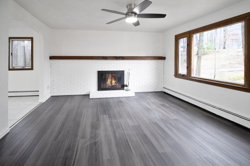 3 Colonial Road Sutton, MA 01590 - Photo 8 of 26 wooden floor in an empty room with a window