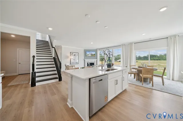 a living room with furniture a fireplace and a large window