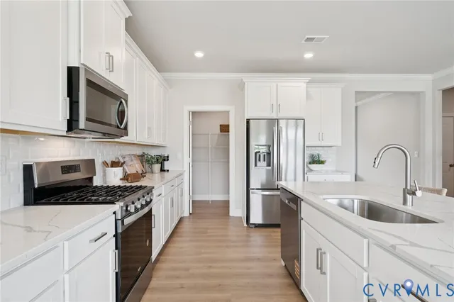 a living room with furniture a fireplace and a large window