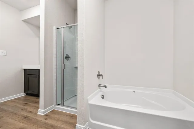 a bathroom with a bathtub and shower