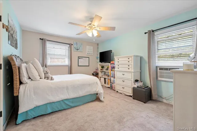 a bedroom with a bed and a flat tv screen