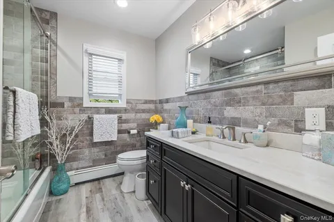 a view of a kitchen with a sink and wooden floor