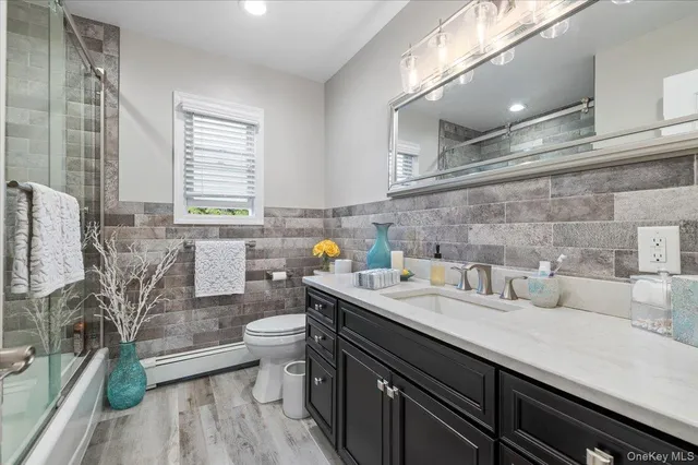 a view of a kitchen with a sink and wooden floor