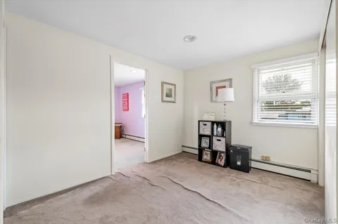 an empty room with bookshelf and a window