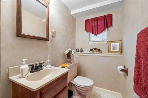 a bathroom with a sink mirror and toilet