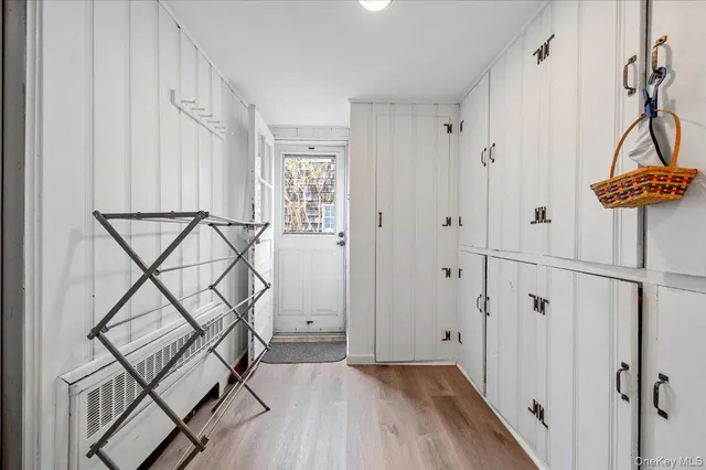 a view of an entryway with wooden floor