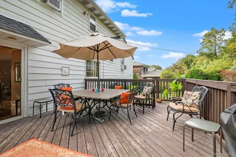 a roof deck with a table and chairs