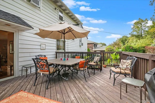 a roof deck with a table and chairs