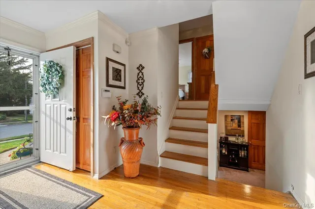 a view of a hallway with wooden floor and windows