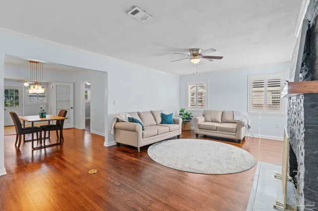 a living room with furniture a dining table and a fireplace
