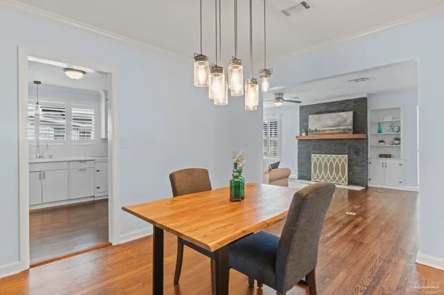 a view of a dining room with furniture wooden floor and chandelier