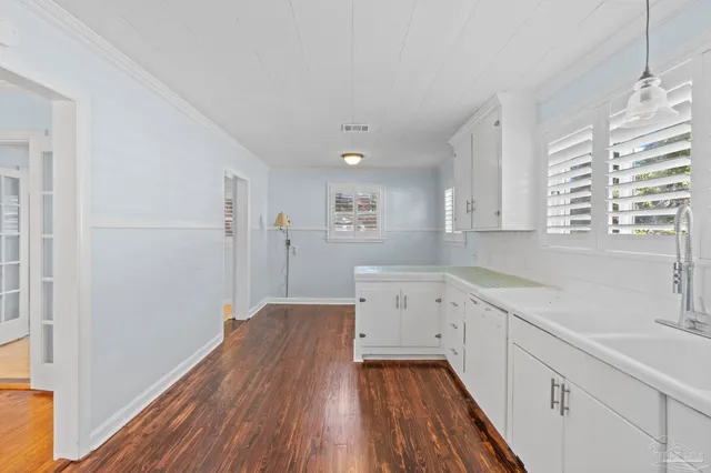 a view of a kitchen with wooden floor